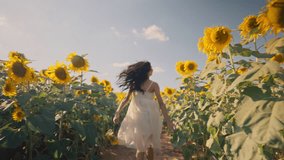 Free asian woman running on yellow sunflower field. Happy young woman jogging through field of a blooming sunflower during summer day. Freedom leisure concept. Slow motion - Powered by Shutterstock - Get 15% off with code: PIKWIZARD15