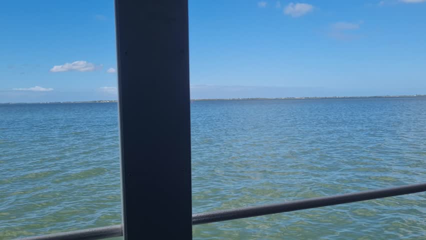 Ferry Boat Araruama Praia Seca (Dry Beach) - Crossing Araruama Lagoon, Brazil, with natural beauty over calm salt waters in a sunny day.  Vacation  at Região dos Lagos.