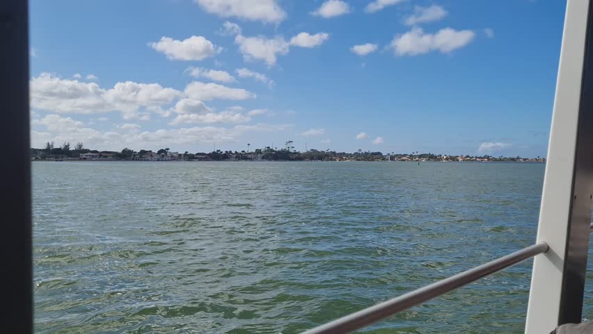 Ferry Boat Araruama Praia Seca (Dry Beach) - Crossing Araruama Lagoon, Brazil, with natural beauty over calm salt waters in a sunny day.  Vacation  at Região dos Lagos.