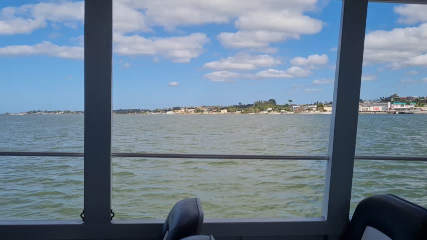 Ferry Boat Araruama Praia Seca (Dry Beach) - Crossing Araruama Lagoon, Brazil, with natural beauty over calm salt waters in a sunny day.  Vacation  at Região dos Lagos.