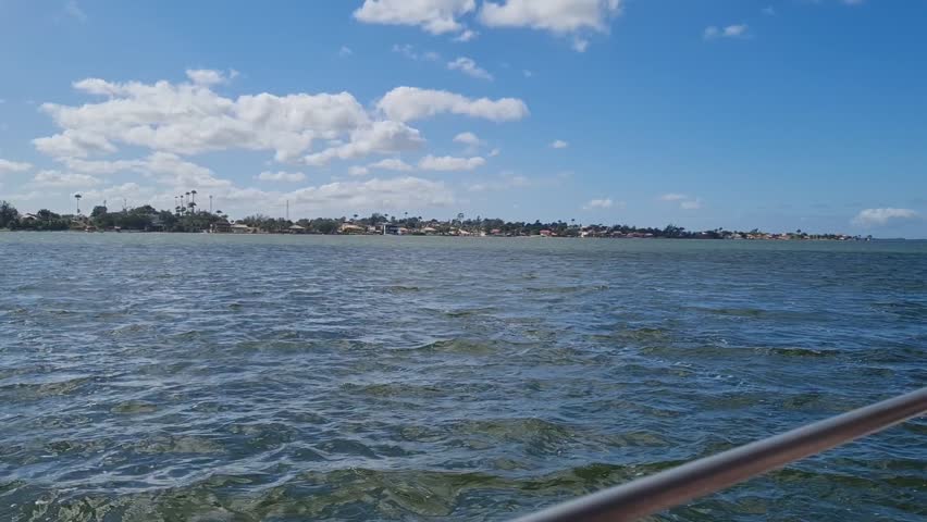 Ferry Boat Araruama Praia Seca (Dry Beach) - Crossing Araruama Lagoon, Brazil, with natural beauty over calm salt waters in a sunny day.  Vacation  at Região dos Lagos.