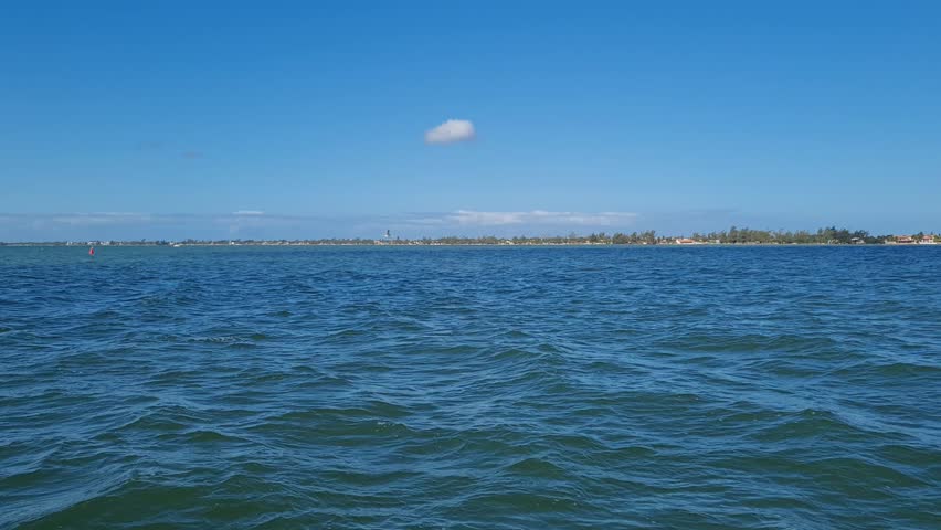 Ferry Boat Araruama Praia Seca (Dry Beach) - Crossing Araruama Lagoon, Brazil, with natural beauty over calm salt waters in a sunny day.  Vacation  at Região dos Lagos.