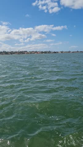 Ferry Boat Araruama Praia Seca (Dry Beach) - Crossing Araruama Lagoon, Brazil, with natural beauty over calm salt waters in a sunny day.  Vacation  at Região dos Lagos.