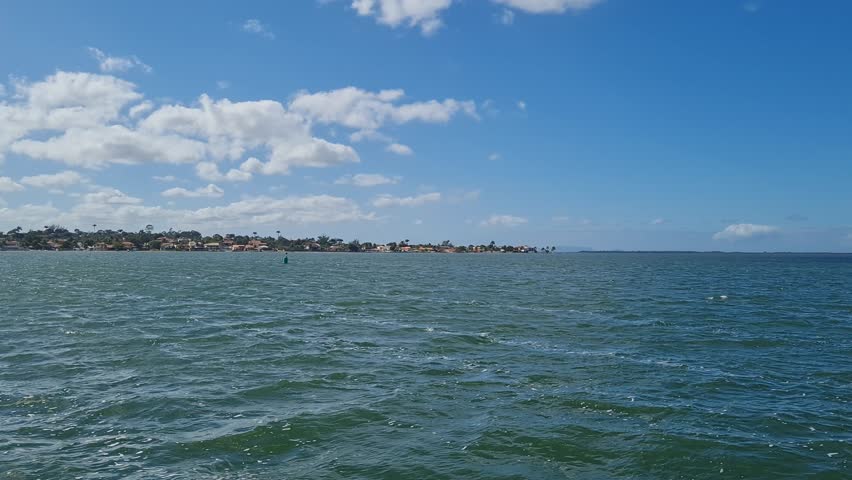 Ferry Boat Araruama Praia Seca (Dry Beach) - Crossing Araruama Lagoon, Brazil, with natural beauty over calm salt waters in a sunny day.  Vacation  at Região dos Lagos.
