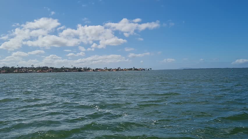 Ferry Boat Araruama Praia Seca (Dry Beach) - Crossing Araruama Lagoon, Brazil, with natural beauty over calm salt waters in a sunny day.  Vacation  at Região dos Lagos.