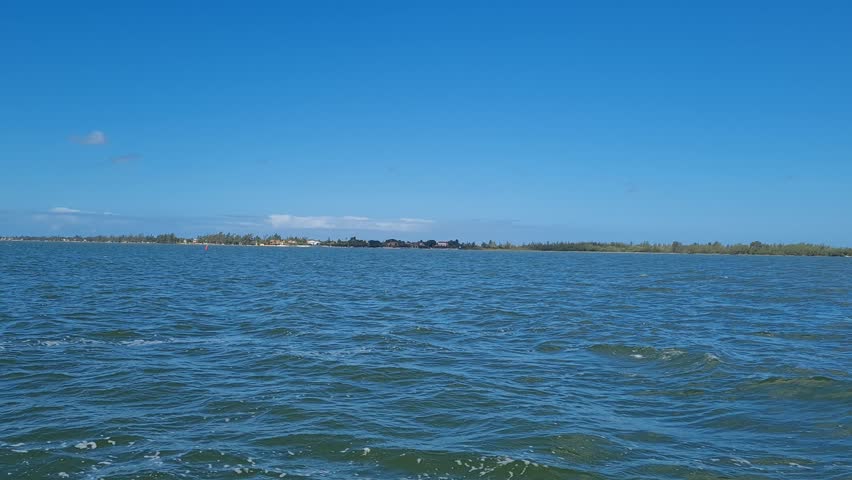 Ferry Boat Araruama Praia Seca (Dry Beach) - Crossing Araruama Lagoon, Brazil, with natural beauty over calm salt waters in a sunny day.  Vacation  at Região dos Lagos.