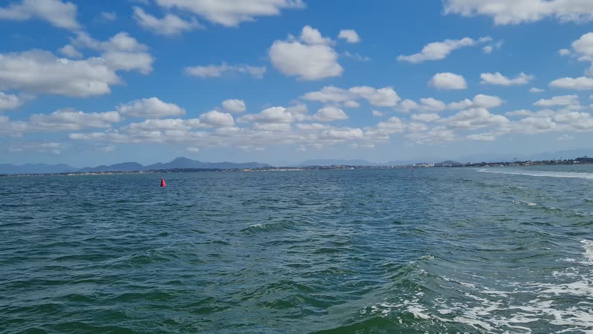 Ferry Boat Araruama Praia Seca (Dry Beach) - Crossing Araruama Lagoon, Brazil, with natural beauty over calm salt waters in a sunny day.  Vacation  at Região dos Lagos.