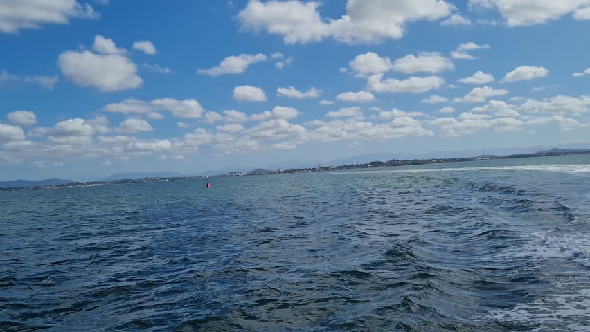 Ferry Boat Araruama Praia Seca (Dry Beach) - Crossing Araruama Lagoon, Brazil, with natural beauty over calm salt waters in a sunny day.  Vacation  at Região dos Lagos.