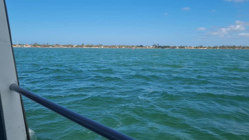 Ferry Boat Araruama Praia Seca (Dry Beach) - Crossing Araruama Lagoon, Brazil, with natural beauty over calm salt waters in a sunny day.  Vacation  at Região dos Lagos.