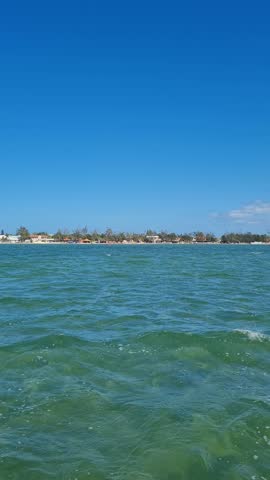 Ferry Boat Araruama Praia Seca (Dry Beach) - Crossing Araruama Lagoon, Brazil, with natural beauty over calm salt waters in a sunny day.  Vacation  at Região dos Lagos.