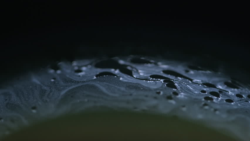 Transparent liquid. Broken hole. Set of caves in pure clear split crushed ice with cracks on modern art black darkened background.