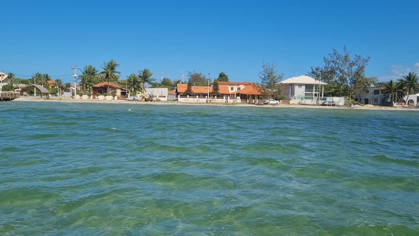 Ferry Boat Araruama Praia Seca (Dry Beach) - Crossing Araruama Lagoon, Brazil, with natural beauty over calm salt waters in a sunny day.  Vacation  at Região dos Lagos.