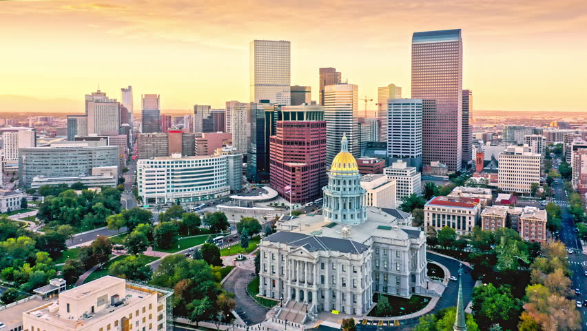 Aerial view of Colorado Capitol and Denver, Colorado skyline at sunset with slow forward motion. Denver is the capital, and most populous city of the US state of Colorado