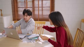 Asian young depressed couple having argument while checking money debt. Attractive new marriage man and woman looking frustrated to paperwork and bill, feel worried about financial problem in house. - Powered by Shutterstock - Get 15% off with code: PIKWIZARD15