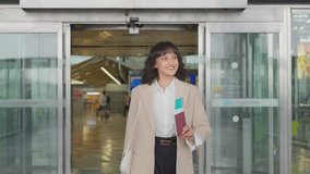 Asian businesswoman passenger walking in airport terminal to boarding gate. Attractive beautiful female tourist feeling happy and excited to outside travel abroad by airplane for holiday vacation trip - Powered by Shutterstock - Get 15% off with code: PIKWIZARD15