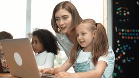 Smart student celebrate successful project while teacher looking at screen and checking system in STEM technology classroom. Diverse learner programing engineering code or coding prompt. Erudition. - Powered by Shutterstock - Get 15% off with code: PIKWIZARD15