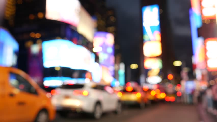 New York City Times Square, Manhattan Midtown Broadway street, USA. American NYC yellow taxi cab, urban road traffic. People. Advertising signs, commercial ads, illuminated billboard screens glowing.