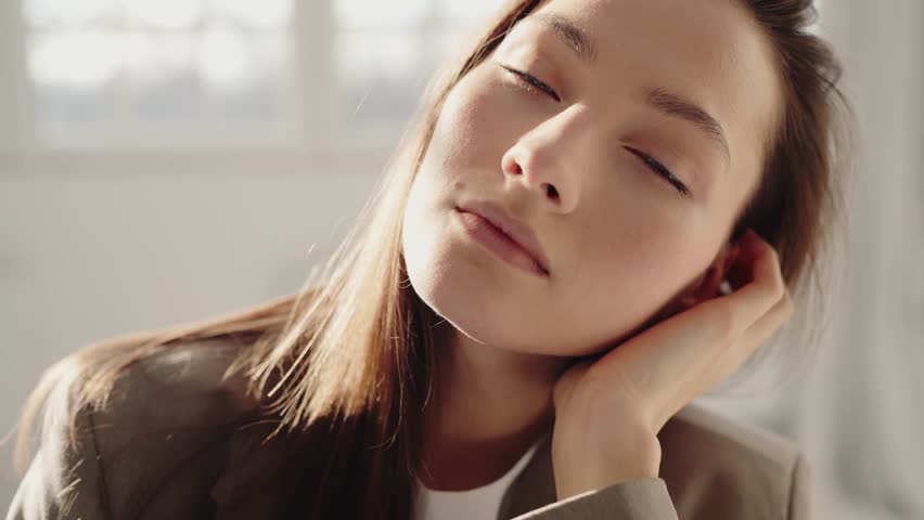 Portrait of beautiful young woman. Beautiful woman having smooth healthy skin. Portrait of gentle female person looking at camera with love. Skincare treatment, cosmetics and anti age plastic surgery.