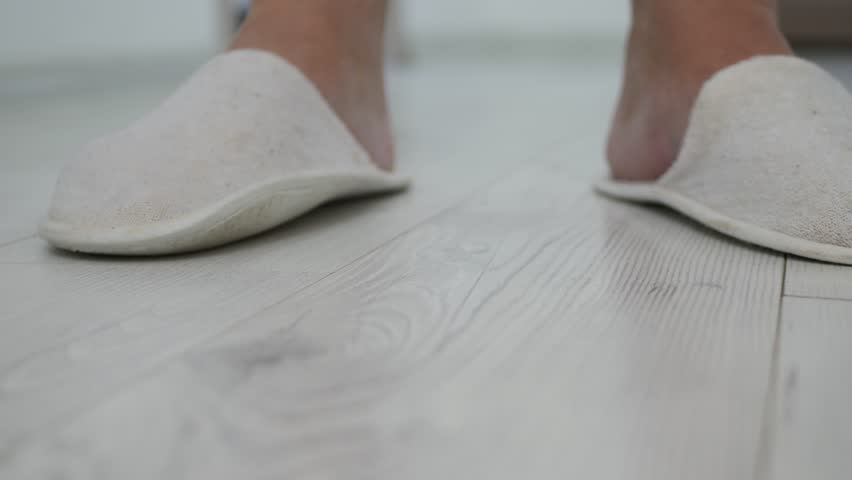 Blurred Shooting with a Man Waiting at the Door, Wearing White Textile Slippers, Making Nervous Foot Gestures and Living the Room.