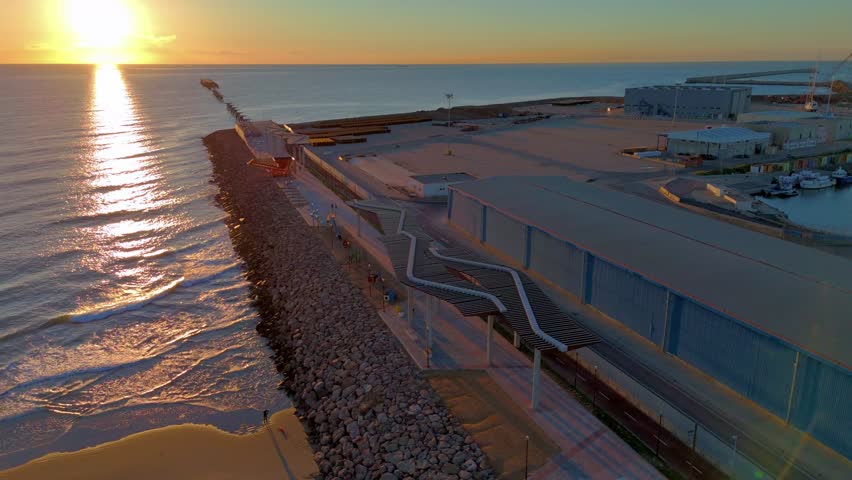 Renovated port of Sagunto breakwater at dawn, Port of Sagunto, Valencia. Drone view in winter.

Espigón del Puerto de Sagunto renovado al amanecer, Puerto de Sagunto, Valencia. Vista de drone.