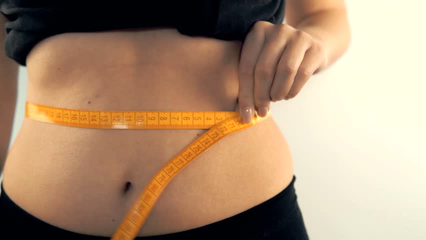 Slim Body Dieting. Sporty Woman Measuring Waist. Diet Weight Loss Care. Successful Diet Plan. Show healthy shape after weight loss. dieting, exercise, body fit, liposuction surgery. Counting Calories
