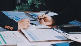 Group of confident business people point to graphs and charts to analyze market data, balance sheet, account, net profit to plan new sales strategies to increase production capacity. - Powered by Shutterstock - Get 15% off with code: PIKWIZARD15