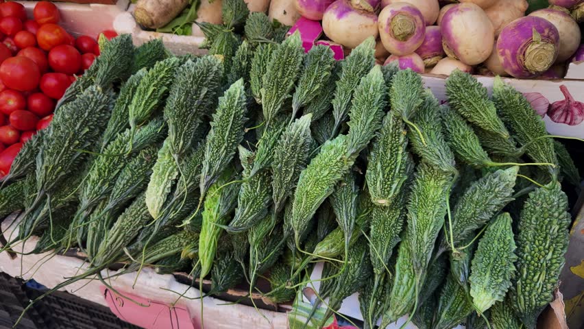 Green bitter melon Momordica charantia, Karela on food market close up.