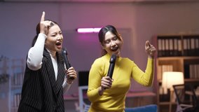 Two young women are taking turns singing karaoke, holding microphones and enjoying their time together - Powered by Shutterstock - Get 15% off with code: PIKWIZARD15