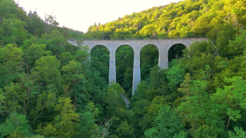 Discover the Zampach railway bridge, the tallest stone bridge in Czechia, surrounded by lush greenery and scenic landscapes. Experience the beauty of this architectural marvel.
