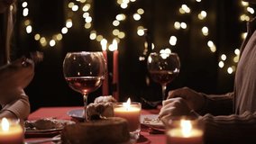 Romantic dinner at home. Couple in love having dinner and drinking wine celebrating Valentine's day or anniversary - Powered by Shutterstock - Get 15% off with code: PIKWIZARD15