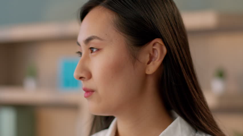 Confident successful Asian Korean business woman female worker girl entrepreneur boss Chinese Japanese businesswoman manager CEO work employer close up turning head looking camera indoors office room