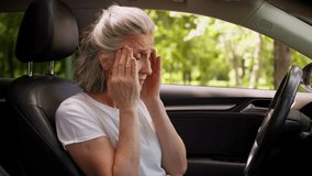 Stressed worried Caucasian suffering aged senior unhealthy woman elderly female automobile driver lady holding head massaging temples suffer headache migraine health problems pressure inside car auto - Powered by Shutterstock - Get 15% off with code: PIKWIZARD15