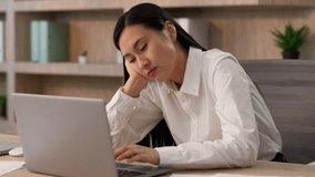 Bored tired exhausted Asian Korean business woman female worker entrepreneur Japanese Chinese businesswoman girl typing laptop working computer boring work unmotivated job task thinking indoor office - Powered by Shutterstock - Get 15% off with code: PIKWIZARD15