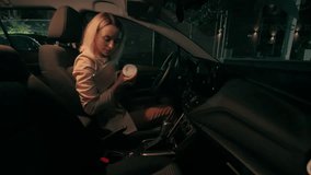 Overworked tired Caucasian business woman female businesswoman girl automobile driver holding coffee cup laptop and mobile phone sitting inside modern car auto driving home leaving work at late night - Powered by Shutterstock - Get 15% off with code: PIKWIZARD15