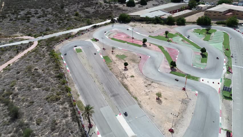 This dynamic video highlights an exciting gokart track from aerial views, showcasing racers navigating twists and turns for the best lap times