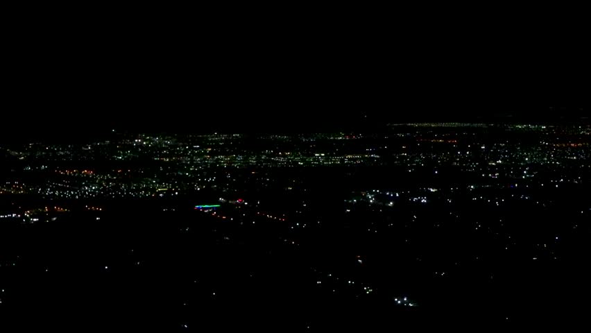 Flight and take off landing airplane over city at night in Cancun Quintana Roo Mexico.