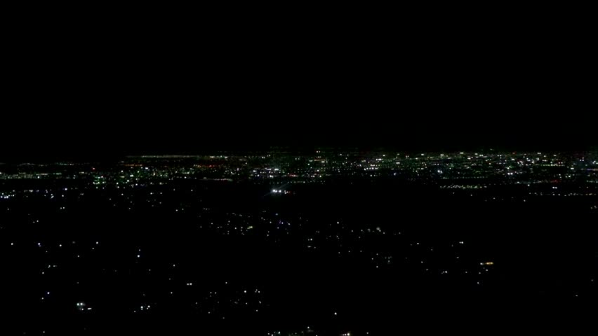 Flight and take off landing airplane over city at night in Cancun Quintana Roo Mexico.