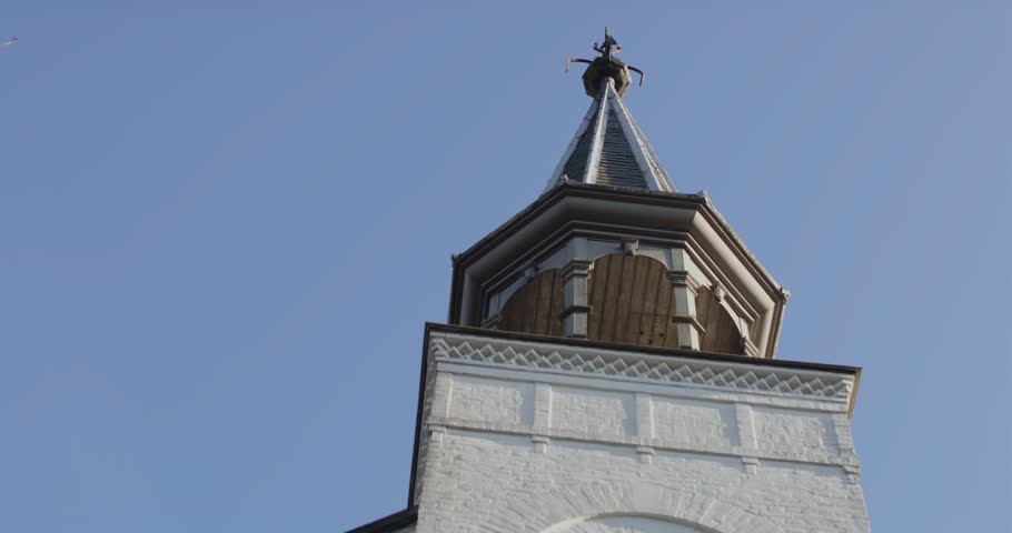 Beautiful close pan of a old white church tower on a sunny day