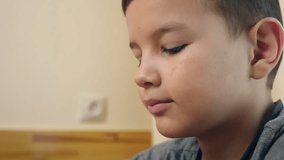 A boy eats cereal with yogurt while sitting at the table. - Powered by Shutterstock - Get 15% off with code: PIKWIZARD15