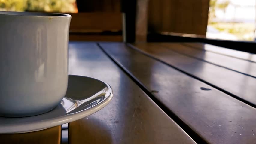 Cup of americano black coffee with spoon and plate on table food and drink in the restaurant in Zicatela Puerto Escondido Oaxaca Mexico.