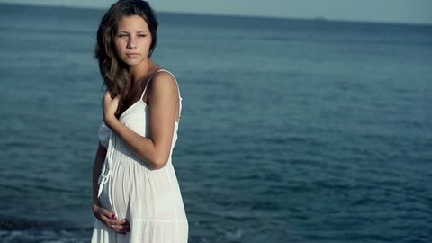 Pregnant woman standing on the seashore, slow motion shot at 120fps
 Stock Video