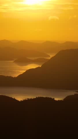 Orange sky over the Islands. Sunset in Philippines. Vertical view.