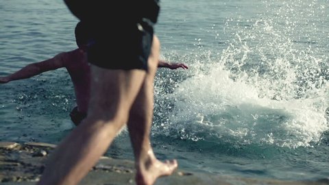 Young three men jumping into the sea, slow motion shot at 240fps
