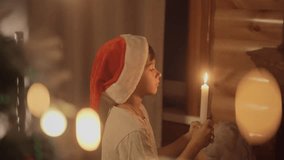 Young boy wearing a santa hat blowing out a candle on christmas and make a wish - Powered by Shutterstock - Get 15% off with code: PIKWIZARD15
