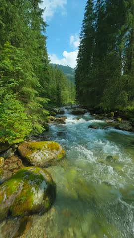 Flight over a mountain river. Shot on FPV drone. Tatra Mountains, Slovakia.