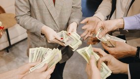 Close up of a business professionals hands holding and distributing cash, symbolizing corporate success, teamwork, and financial achievement - Powered by Shutterstock - Get 15% off with code: PIKWIZARD15