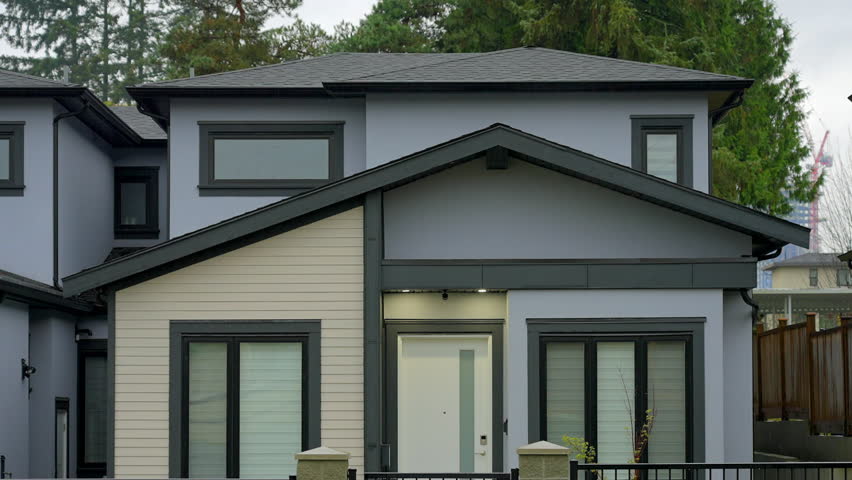 Establishing shot. Top of luxury house with big tree and nice landscape at fall rainfall in Vancouver, Canada, North America. Day time on November 2024. ProRes 422 HQ.