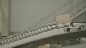 A cardboard box travels on a conveyor belt in a warehouse distribution center - Powered by Shutterstock - Get 15% off with code: PIKWIZARD15