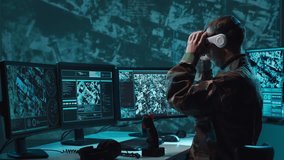 Military soldier operating advanced technology in a command center. - Powered by Shutterstock - Get 15% off with code: PIKWIZARD15