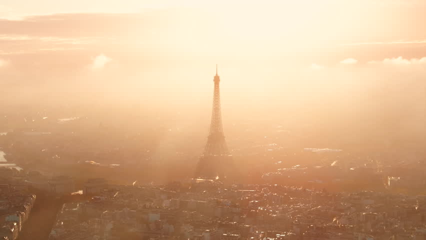 Aerial shot of the Eiffel tower silhouetted by the sunrise